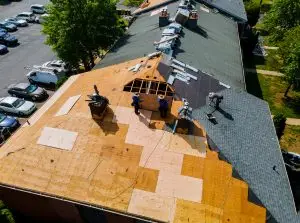 Construction worker on a renovation roof the house installed new shingles