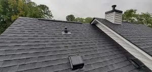 Newly Installed Black Asphalt Architectural Shingles on a Residential Home: Architecture, Roofing, Real Estate